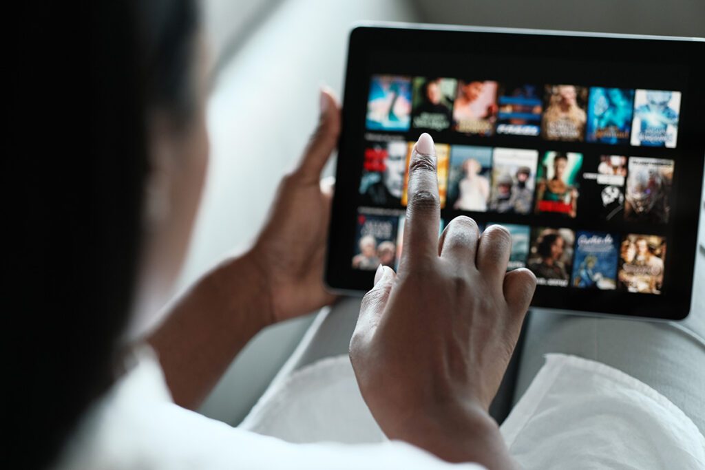 Woman Browsing Movie On Streaming Media Service.